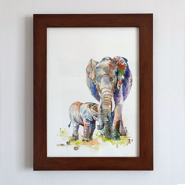 Elephant and calf watercolour painting framed in dark-brown wooden photo frame on a wall